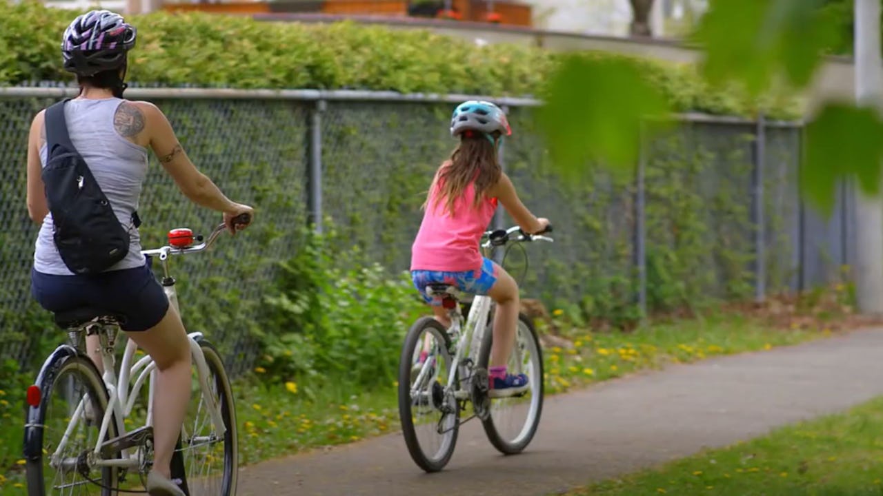 Mother and daughter on bike path
