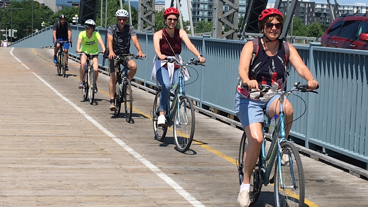 People on a bicycles on a bridge