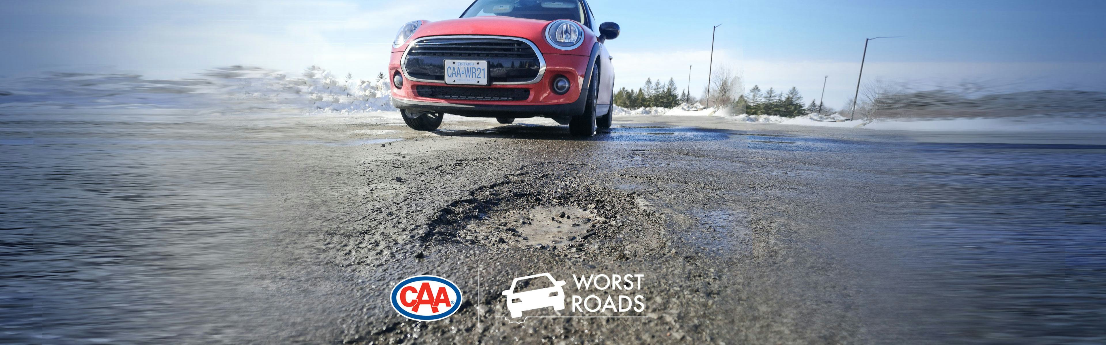 Image of red car parked on an Ontario street near a pothole. CAA logo. Worst Roads logo. 