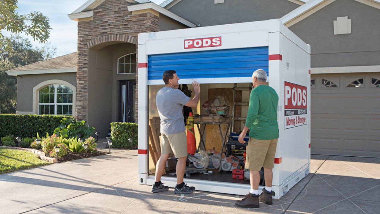 Two men opening a PODS storage container