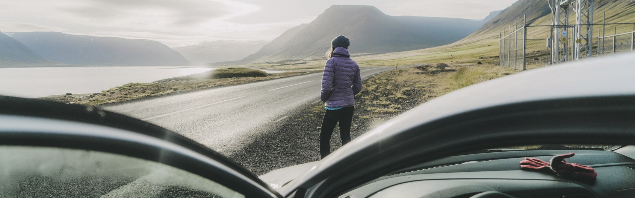 Women standing outside of rental car in Iceland