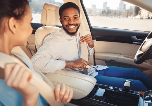 Couple in a car fastening their seat belts 