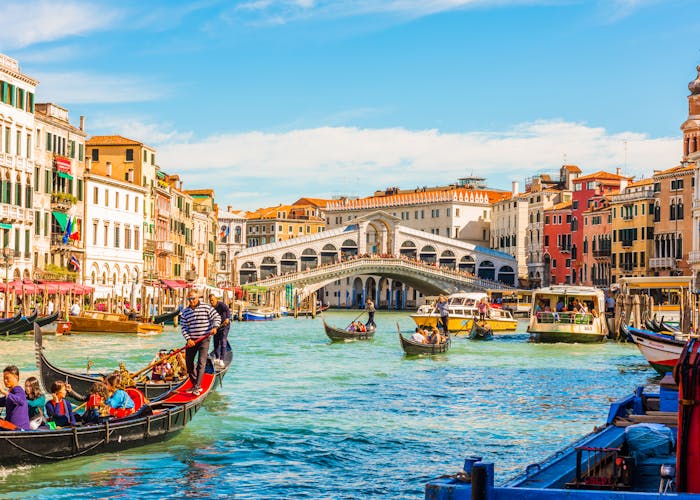Panoramic view of the Grand Canal with gondolas and the Rialto Bridge, Venice, Italy