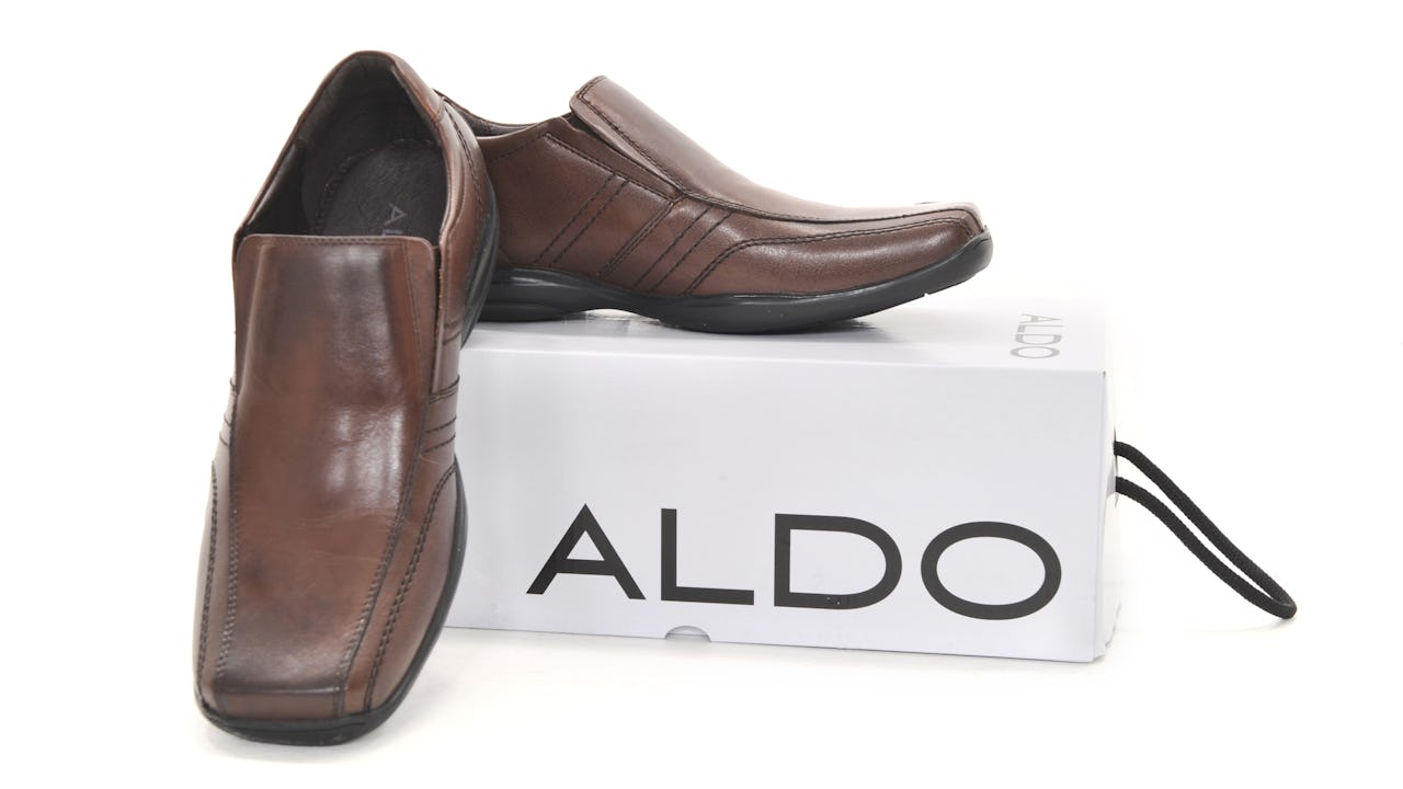 Men's dress shoes on an Aldo shoe box