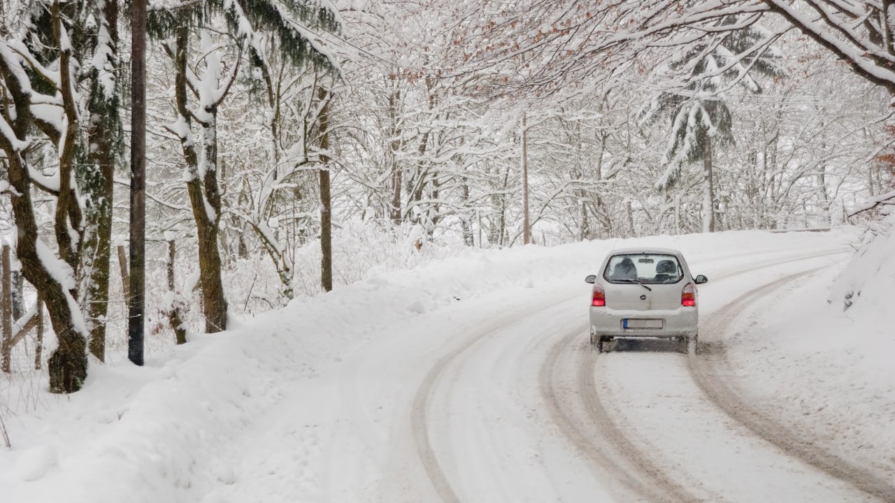 car driving on a winter road in forest. Winter driving can be challenging, luckily CAA is here to help.