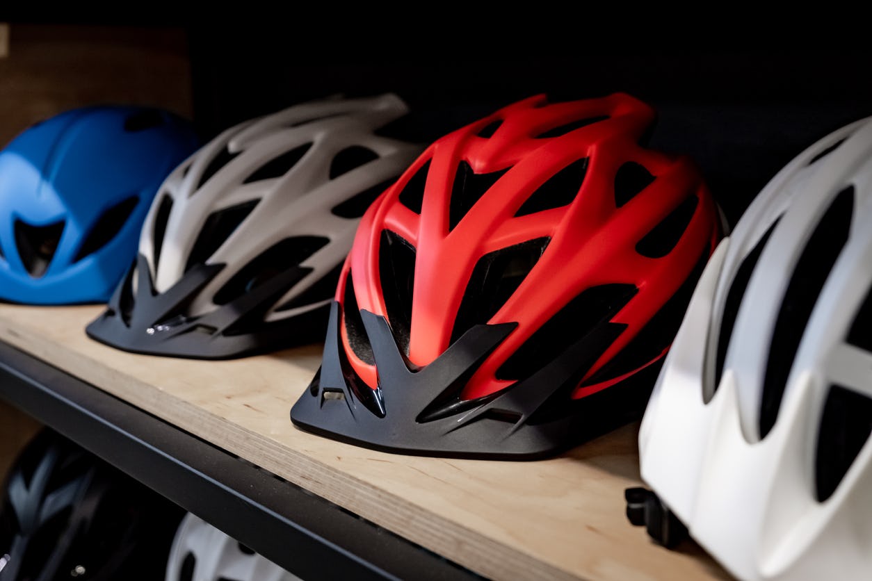 Multicolored bicycle helmets lying in a row