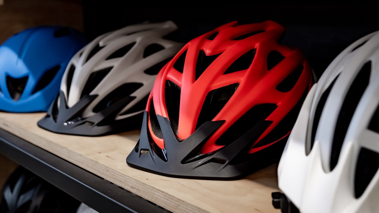 Multicolored bicycle helmets lying in a row