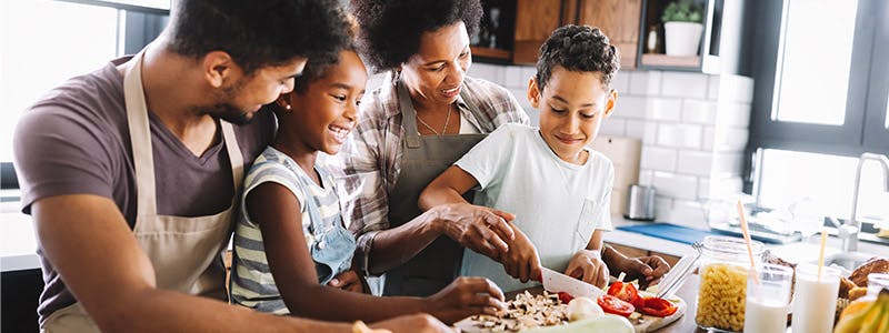 Family working together in the kitchen to prepare a meal
