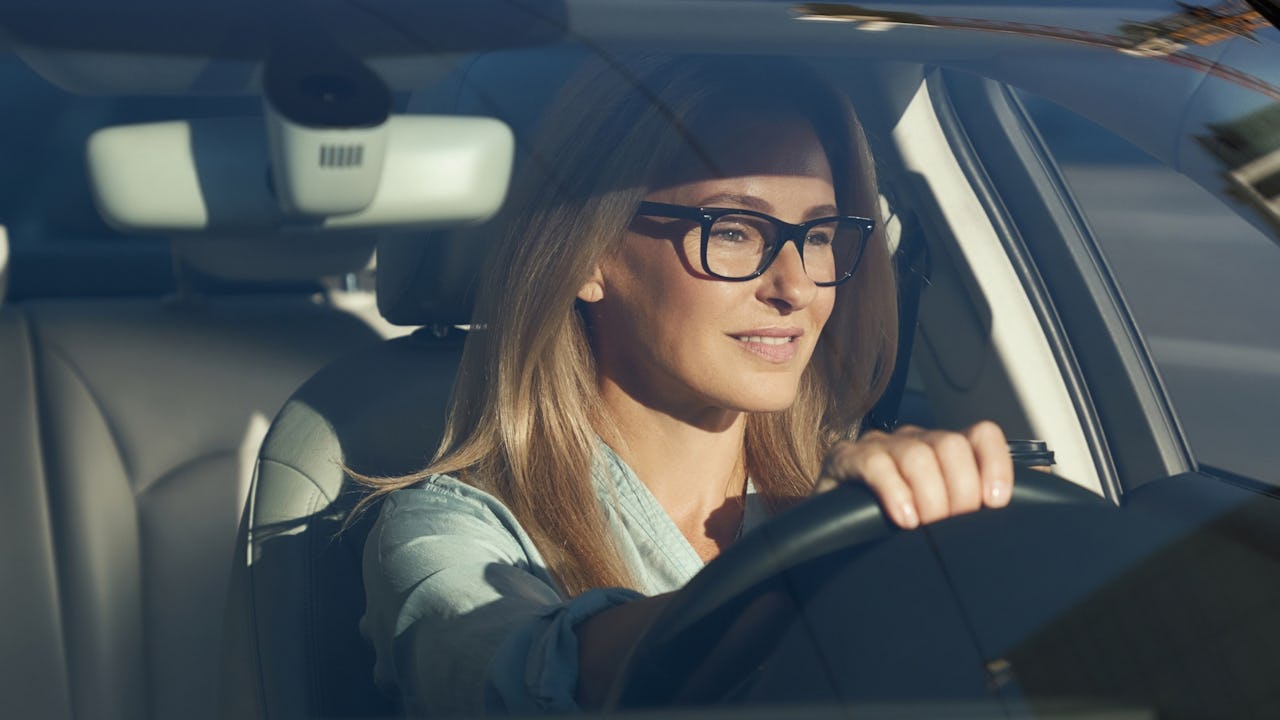 Women driving wearing glasses