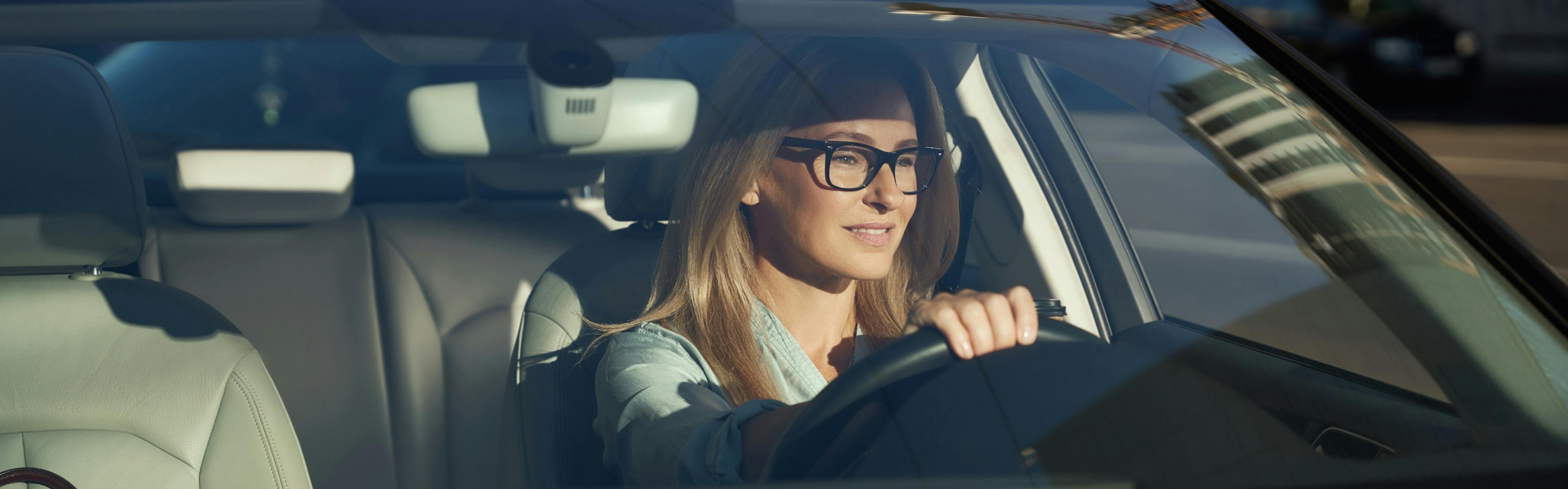 Women driving wearing glasses