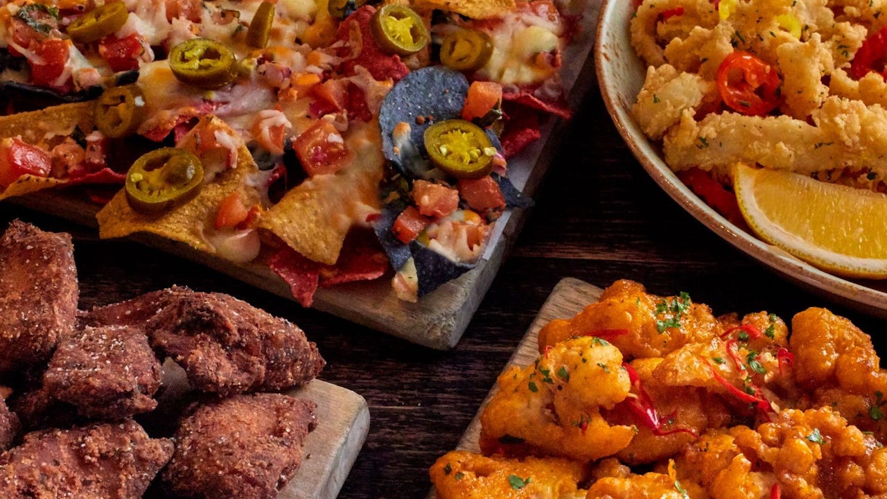 Image of nachos, wings, calamari and popcorn shrimp from Bier Markt