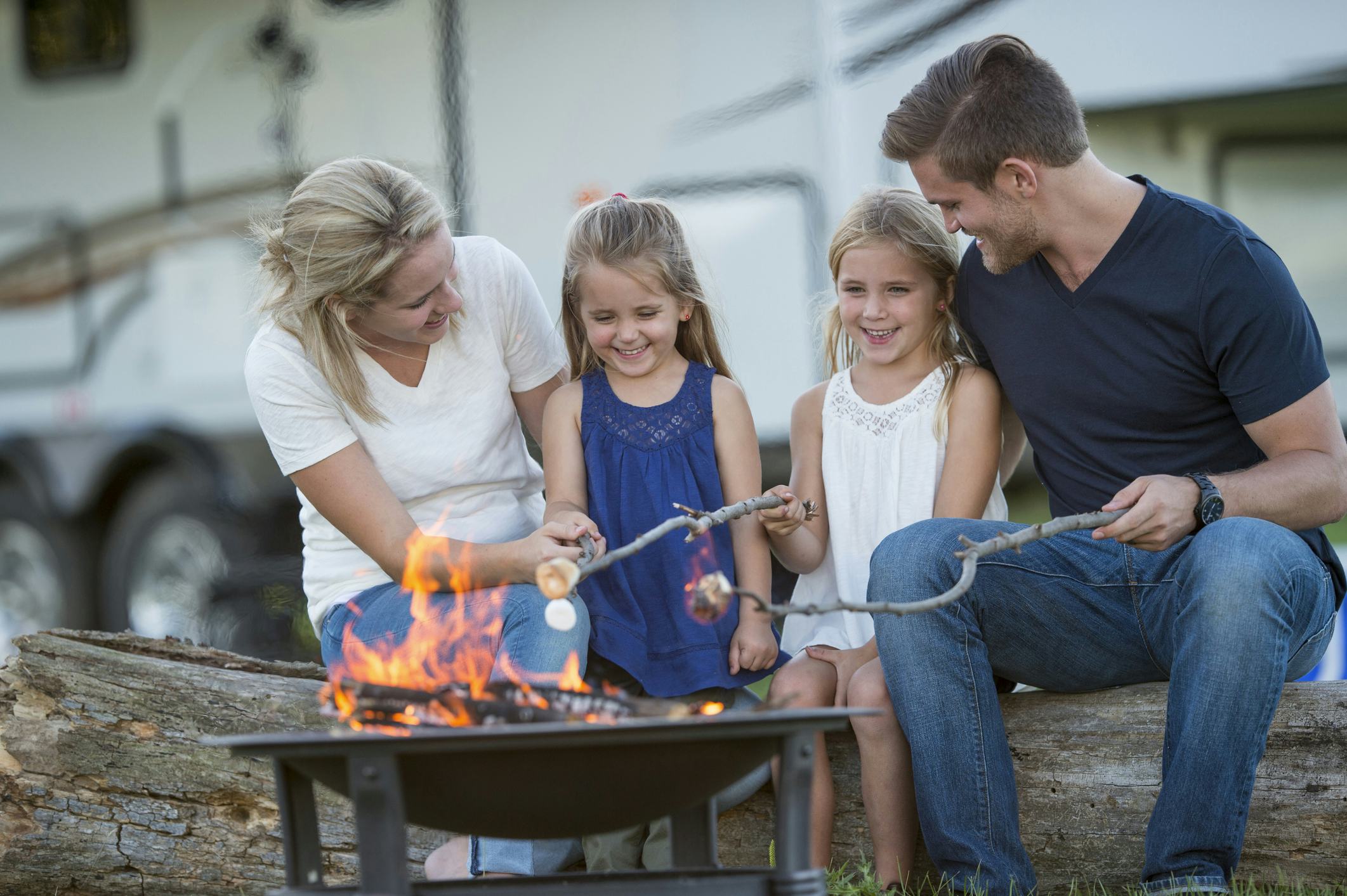 Family roasting Marshmallow on campfire