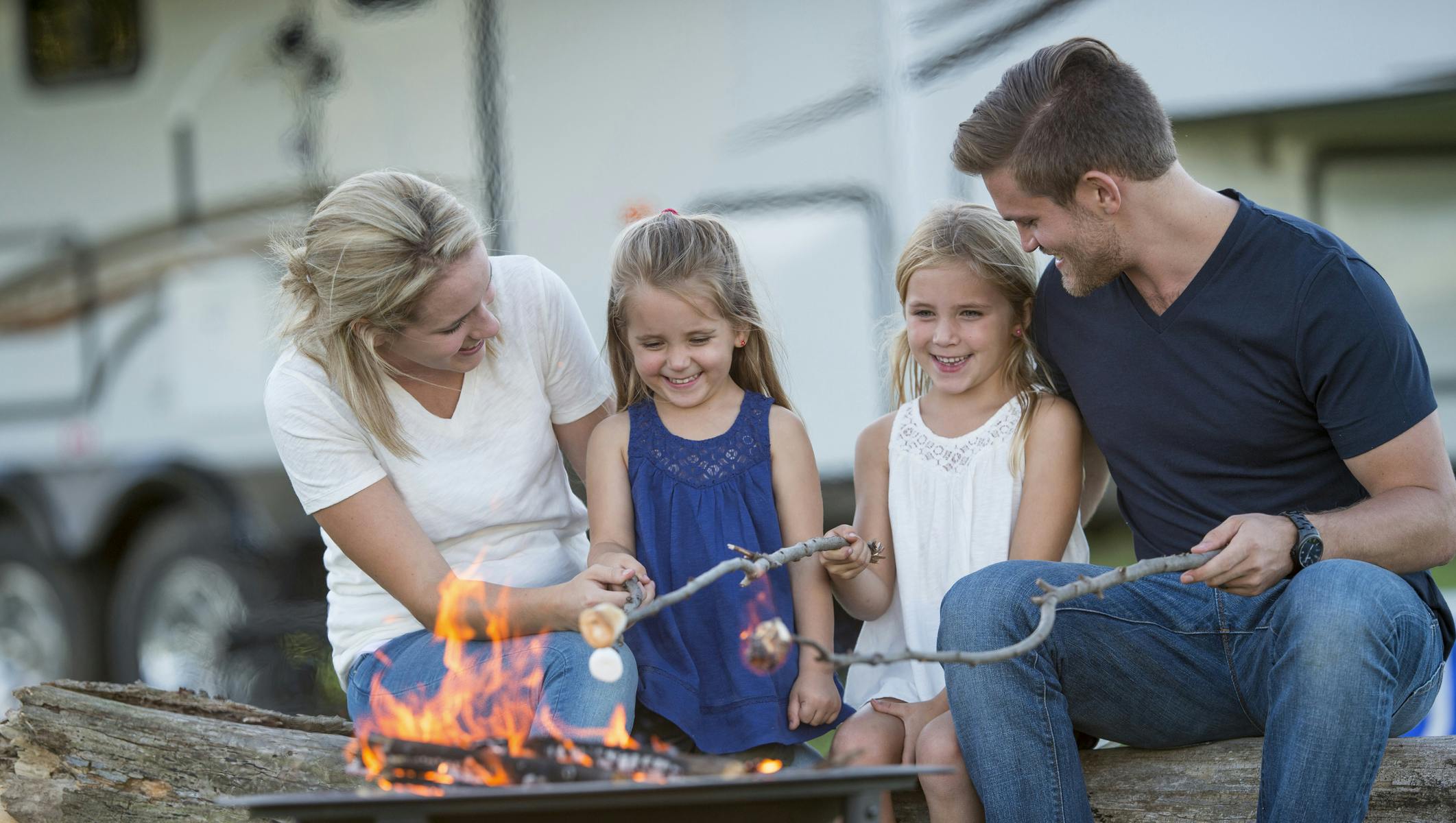 Family roasting Marshmallow on campfire