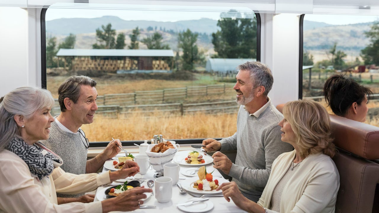 Group of people dining onboard Rocky Mountaineer in GoldLeaf Service 