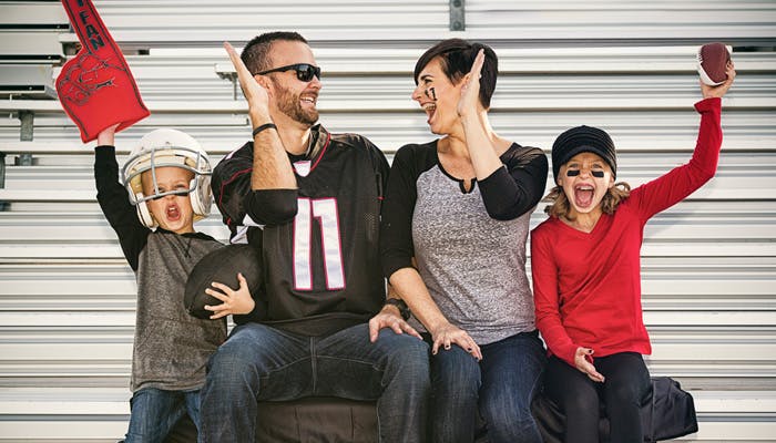 Family watching football game together in stands