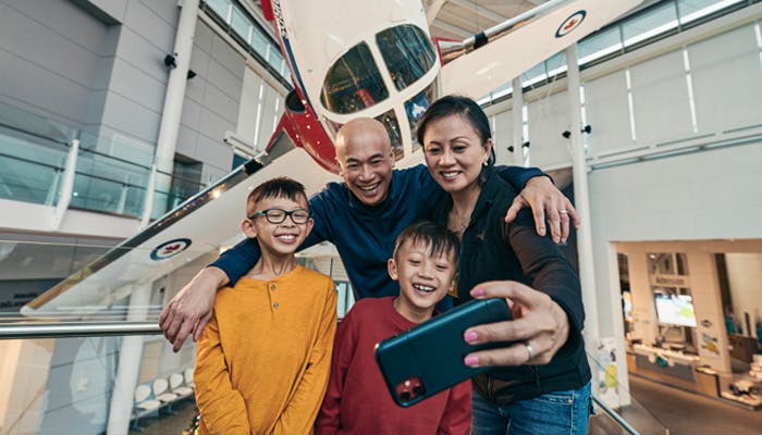 Family taking selfie photo at aviation museum