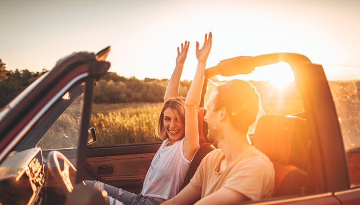 Couple in a convertible car in the summer