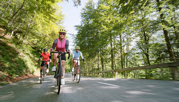 People biking on open road