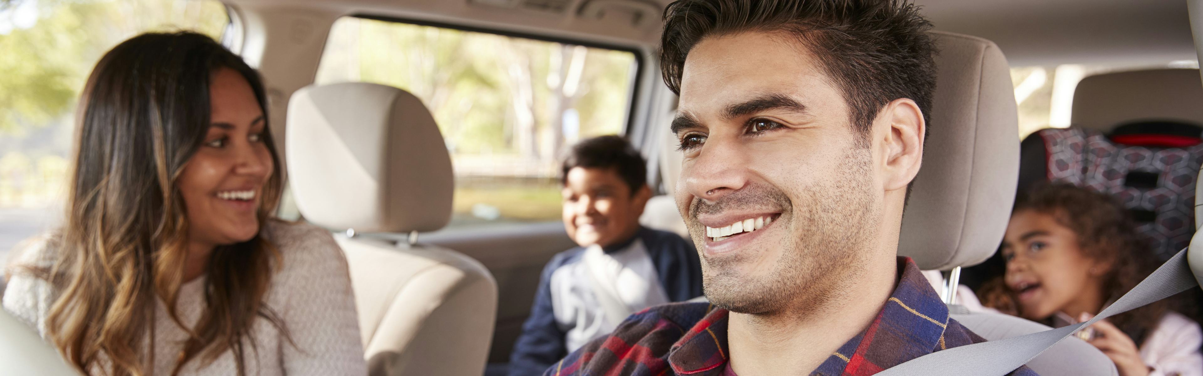 Family driving in car, smiling with CAA Membership benefits