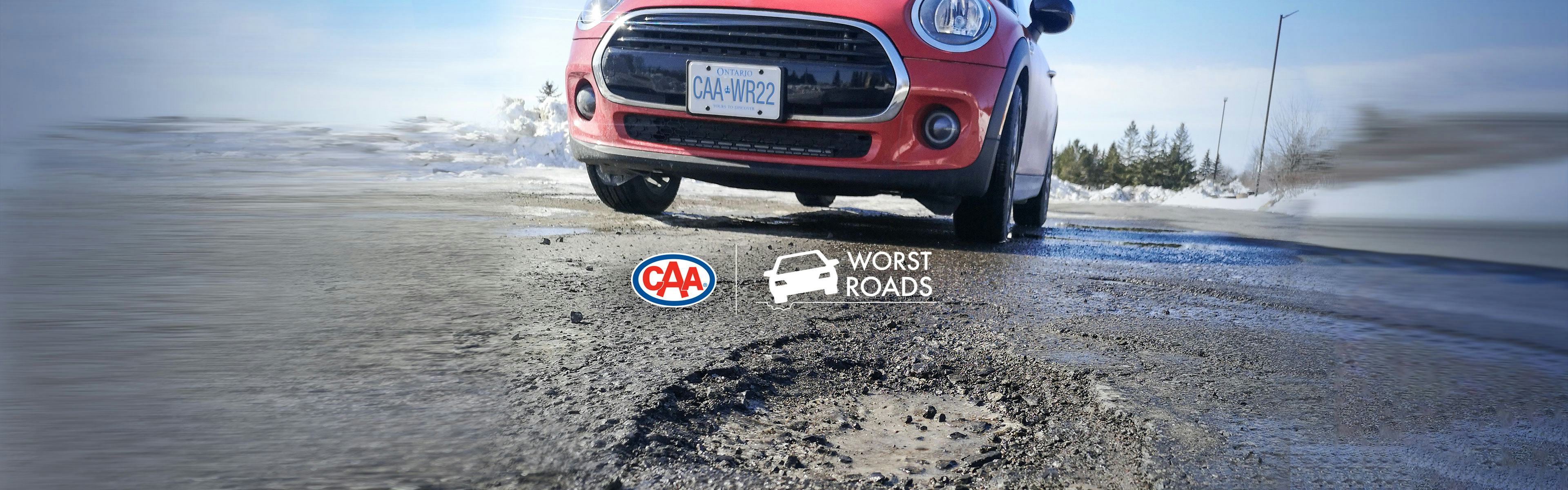 CAA's Worst Roads 2022 - Red car parked on an Ontario street near a pothole.