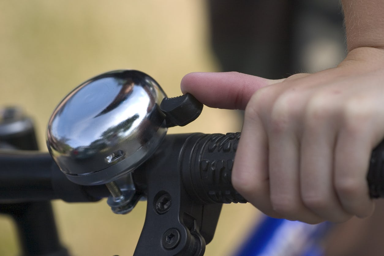 Close up of bicycle bell on handlebars.