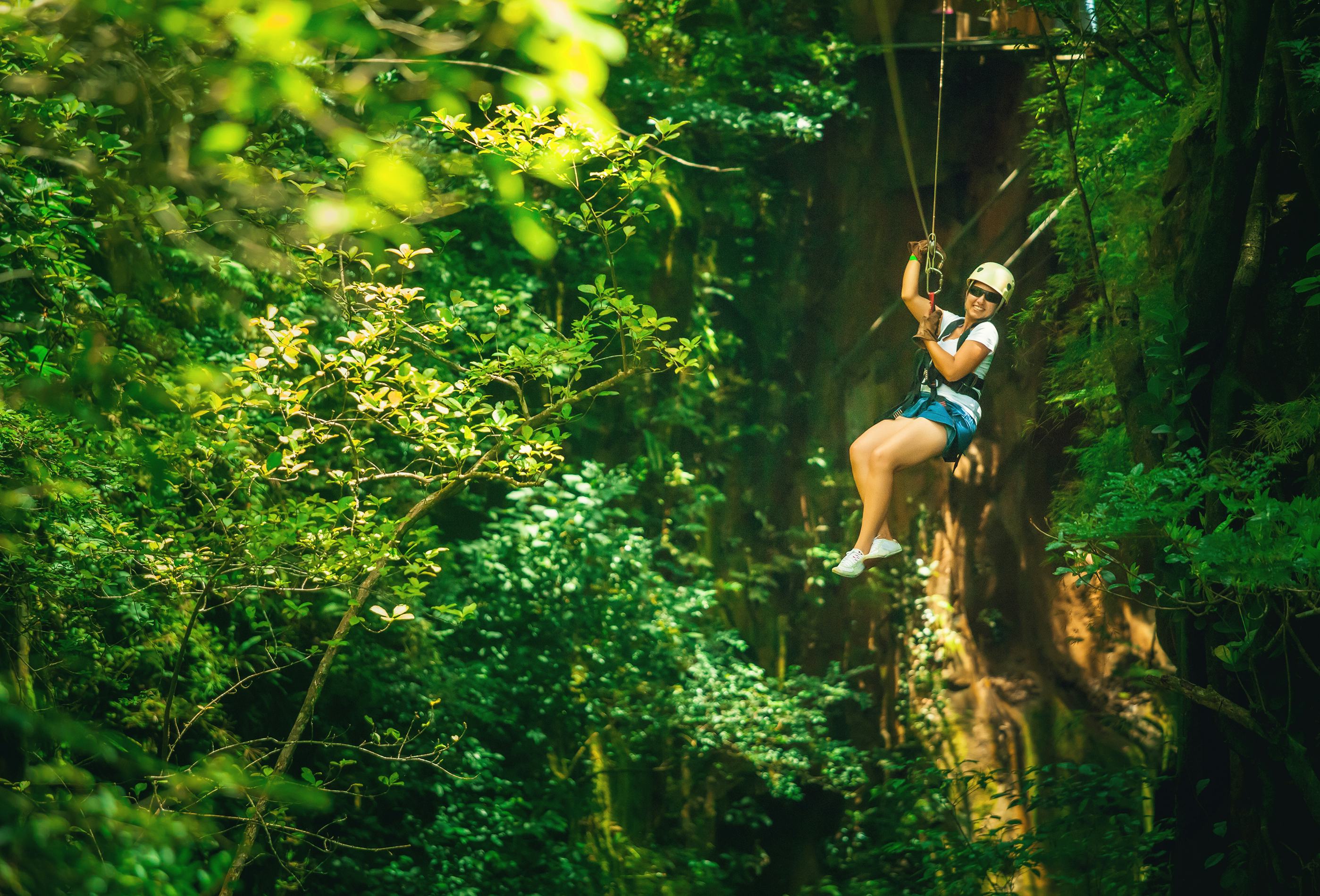 Woman during a Canopy Tour in Costa Rica, ziplining through the rainforest 
