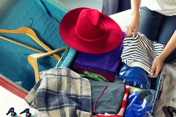 Girl packing luggage for trip