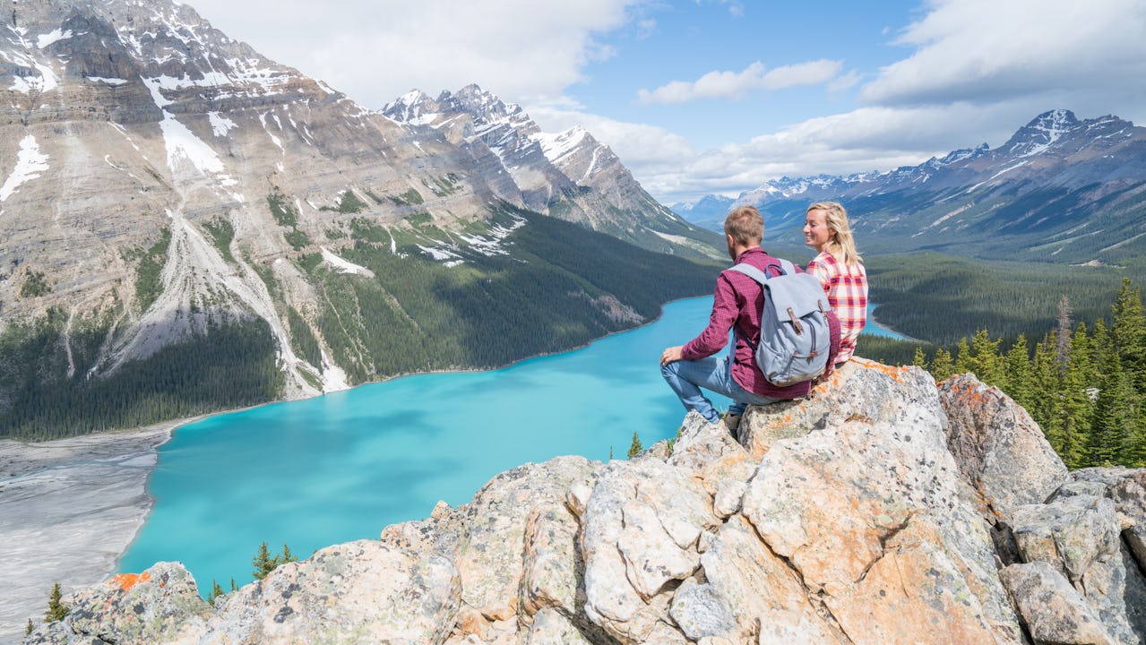 Couple sitting on a mountain in Canada 

