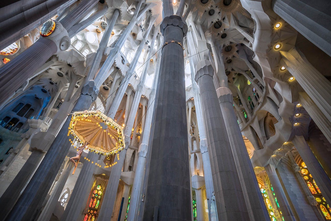 Impressive Sagrada Familia cathedral interior filled with countless columns.