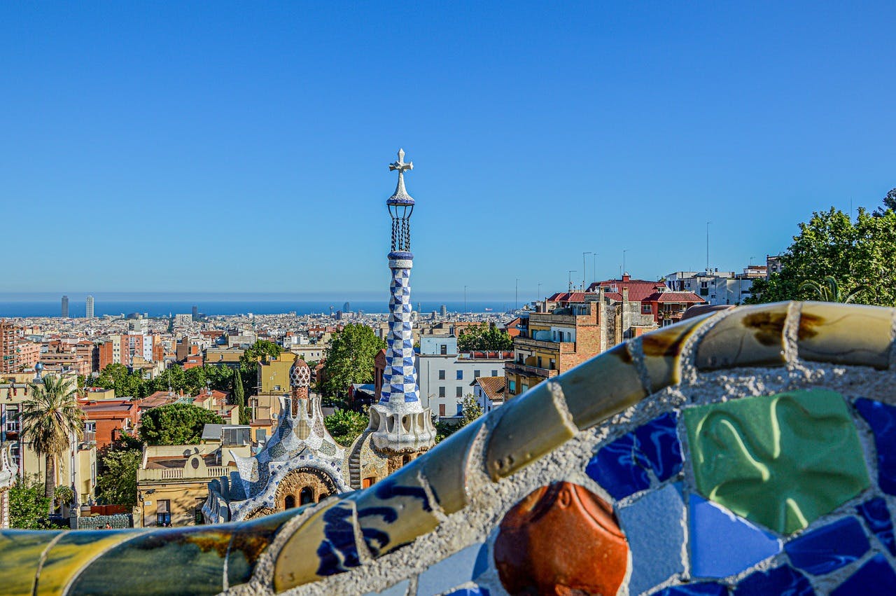 A breathtaking cityscape of Barcelona is seen from a balcony at Parc Güell.