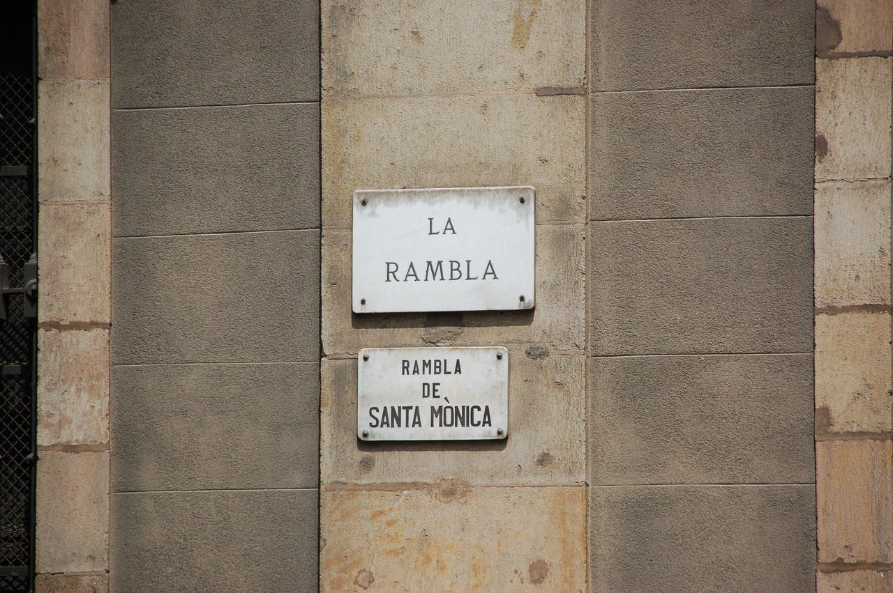 A street sign on a building in Las Ramblas.