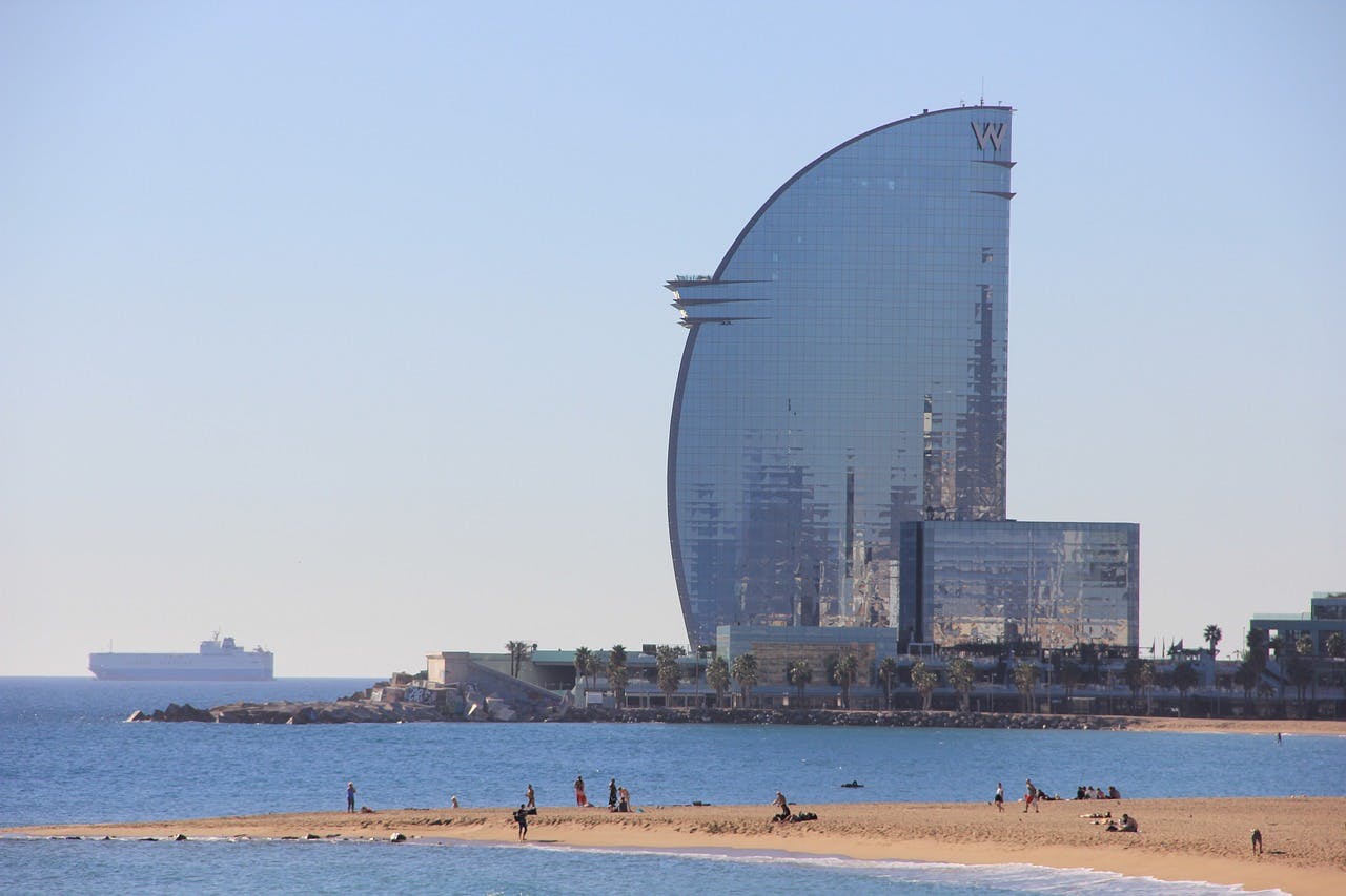 with its modern architecture and glass windows reflecting the clear blue sky.