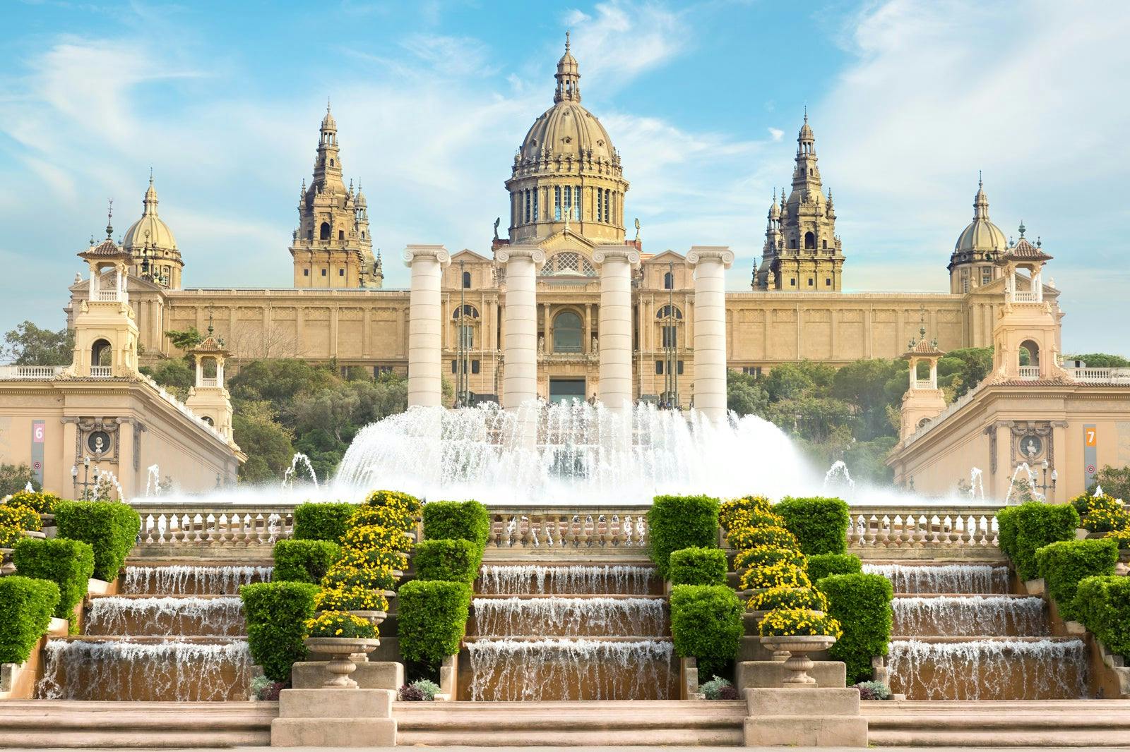 The Palace of Justice in Barcelona, Spain, with the enchanting Magic Fountain of Montjuïc in the foreground.