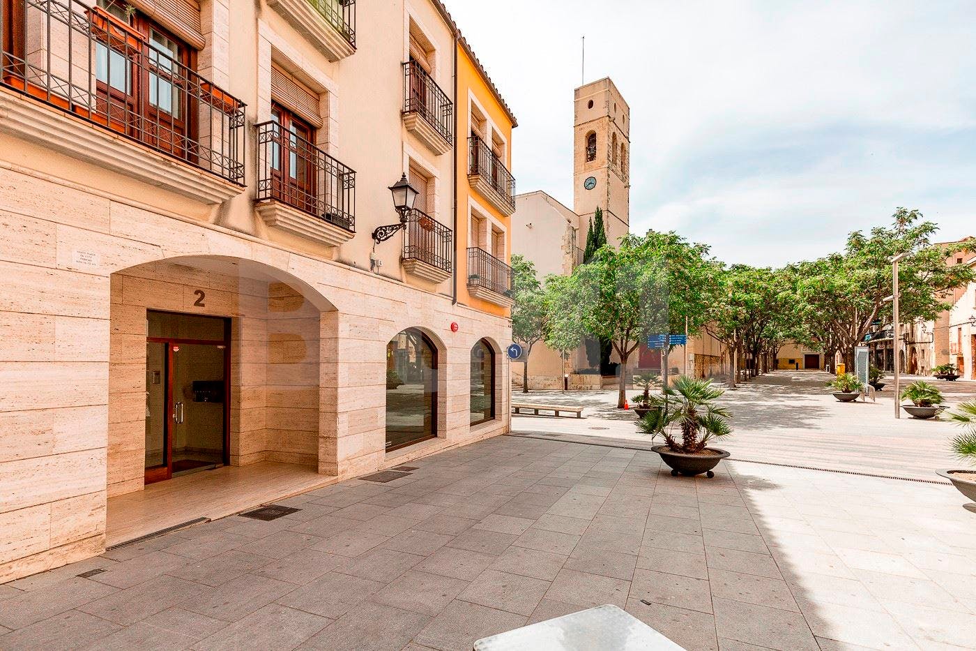 A building in Vila-Seca with a tower in the background.