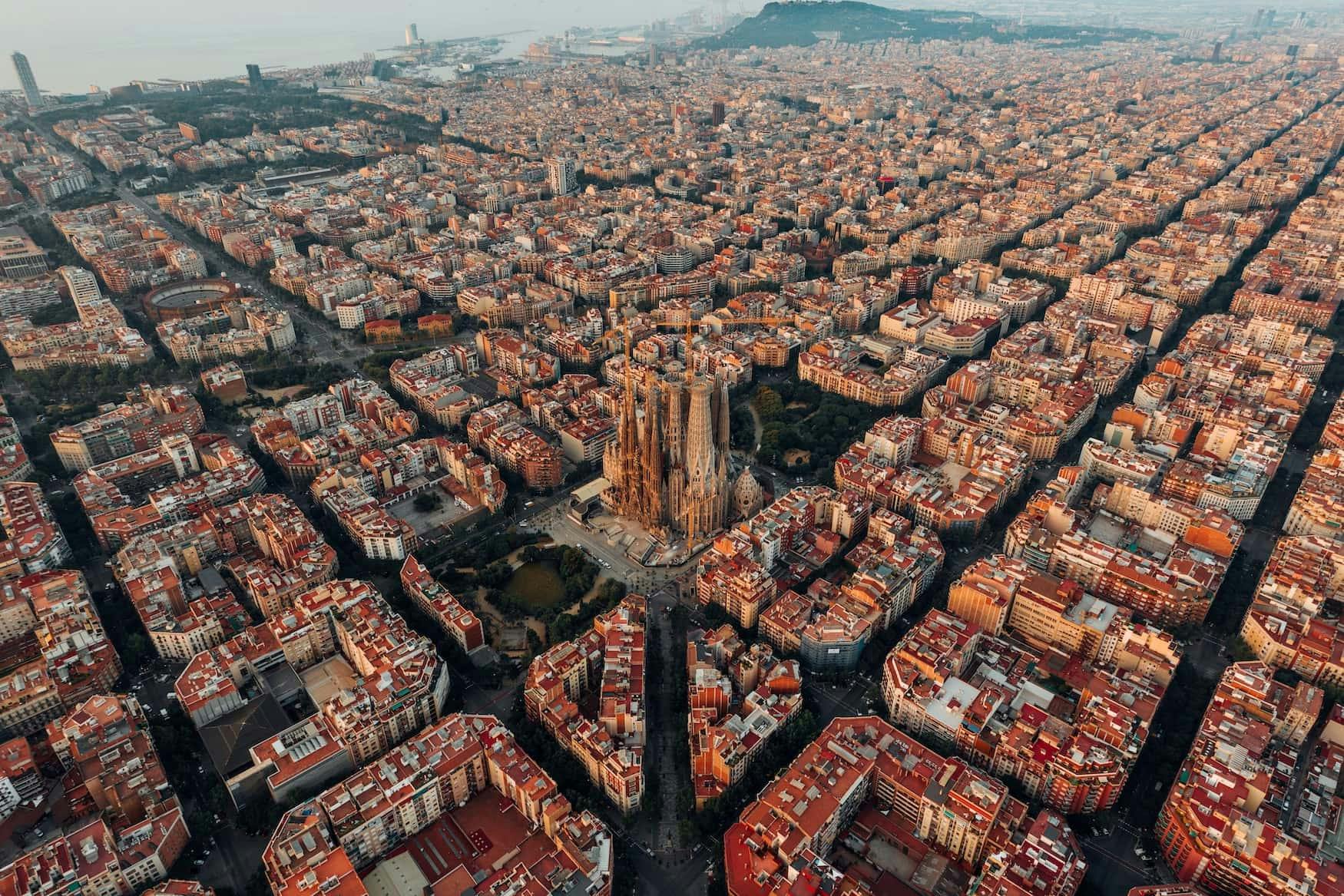 Aerial view of Barcelona, Spain at sunset showcasing the city's stunning skyline and vibrant atmosphere.