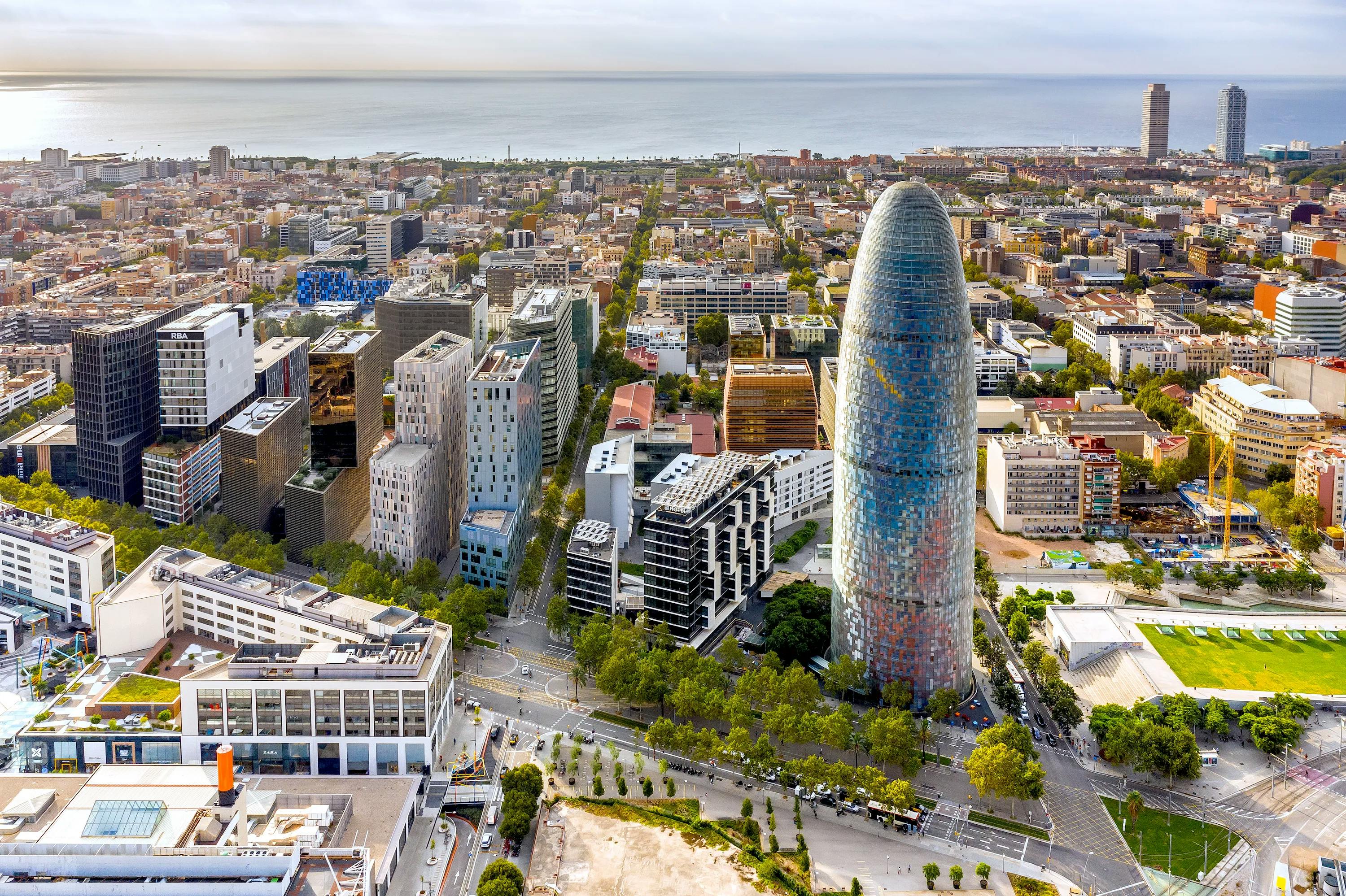 Aerial view of Barcelona city with Torre Glòries, showcasing the vibrant urban landscape.