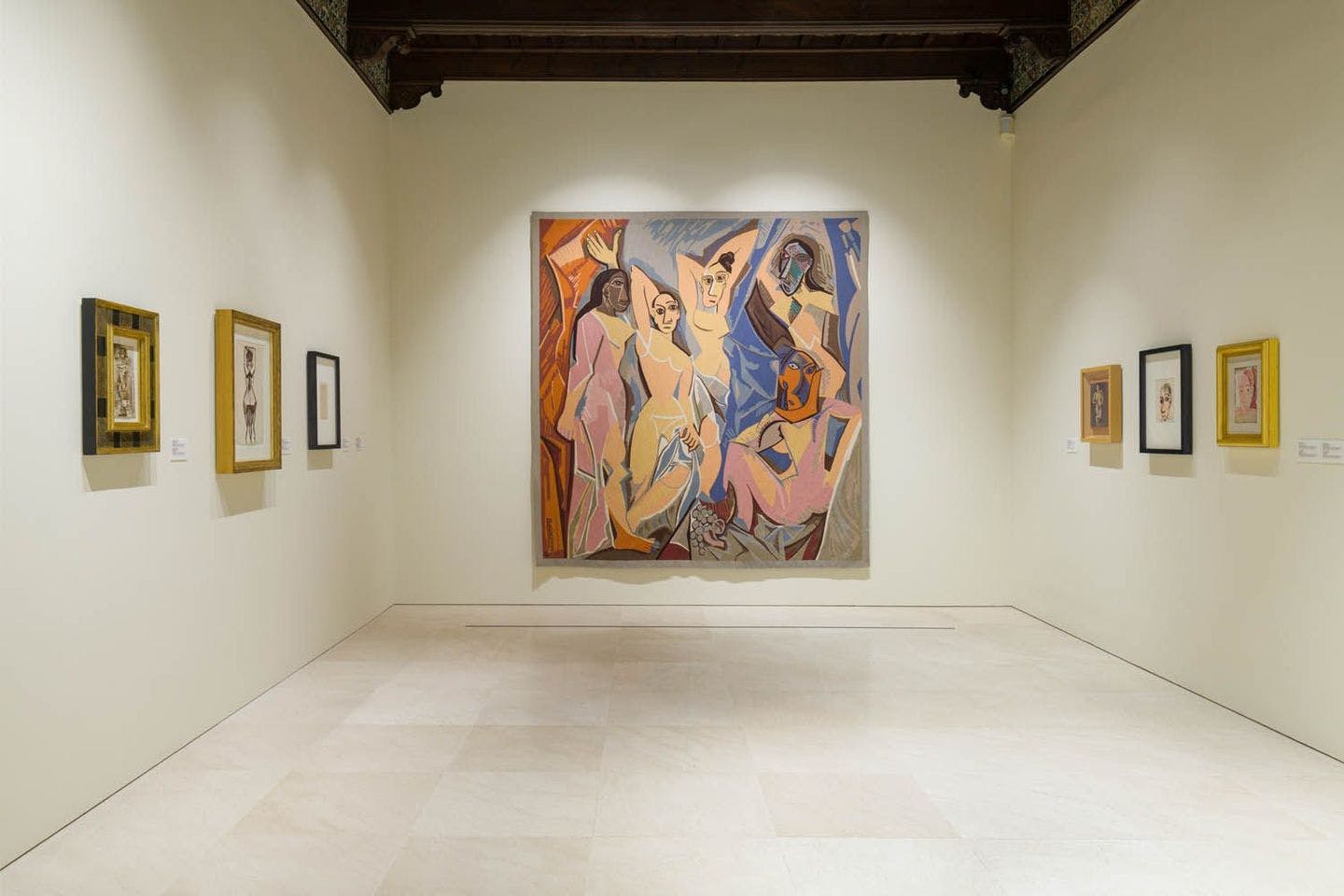 Art-filled room at Museo Picasso showcasing diverse paintings on the wall.