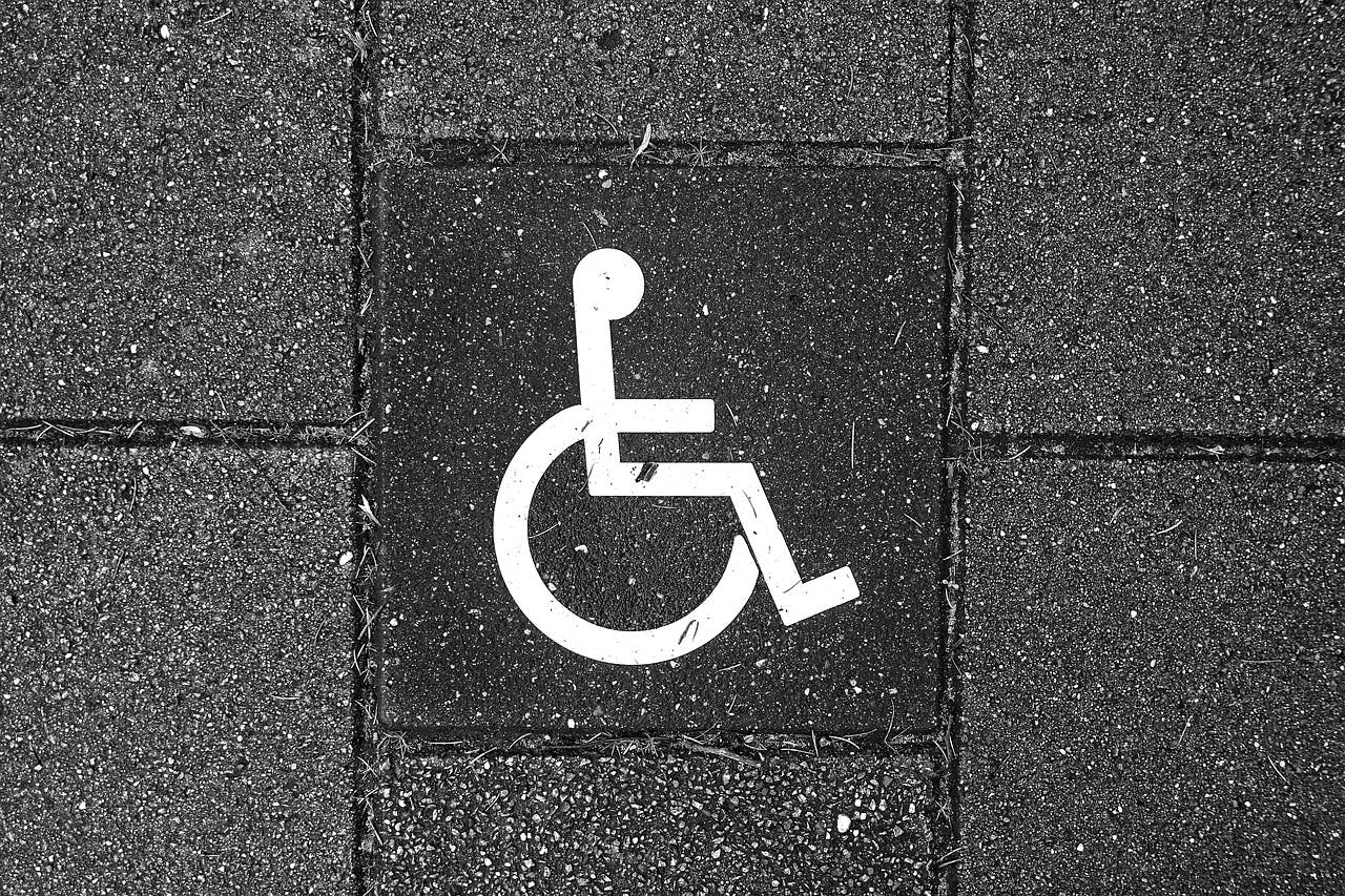 A sign symbolizing disability and accessibility.