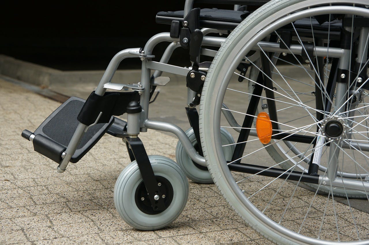 A  modern wheelchair, showcasing its design and functionality for an individual with a disability.