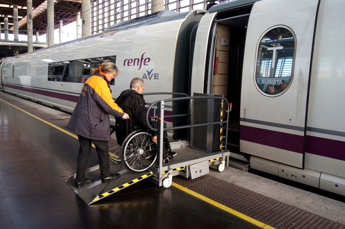 A wheelchair user boarding a train at a train station in Spain, highlighting its platform access.