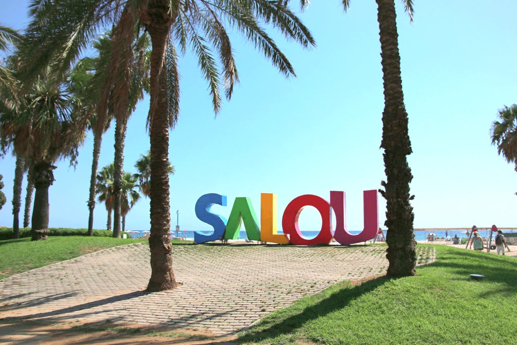 A colorful, eye-catching sign with the words "Salou" written in large letters. It beckons tourists to come and visit this vibrant location in Spain.