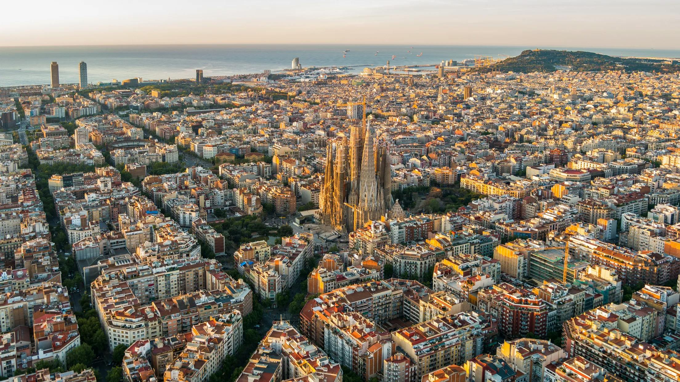 Aerial view of Barcelona with the iconic Sagrada Familia church in the background.