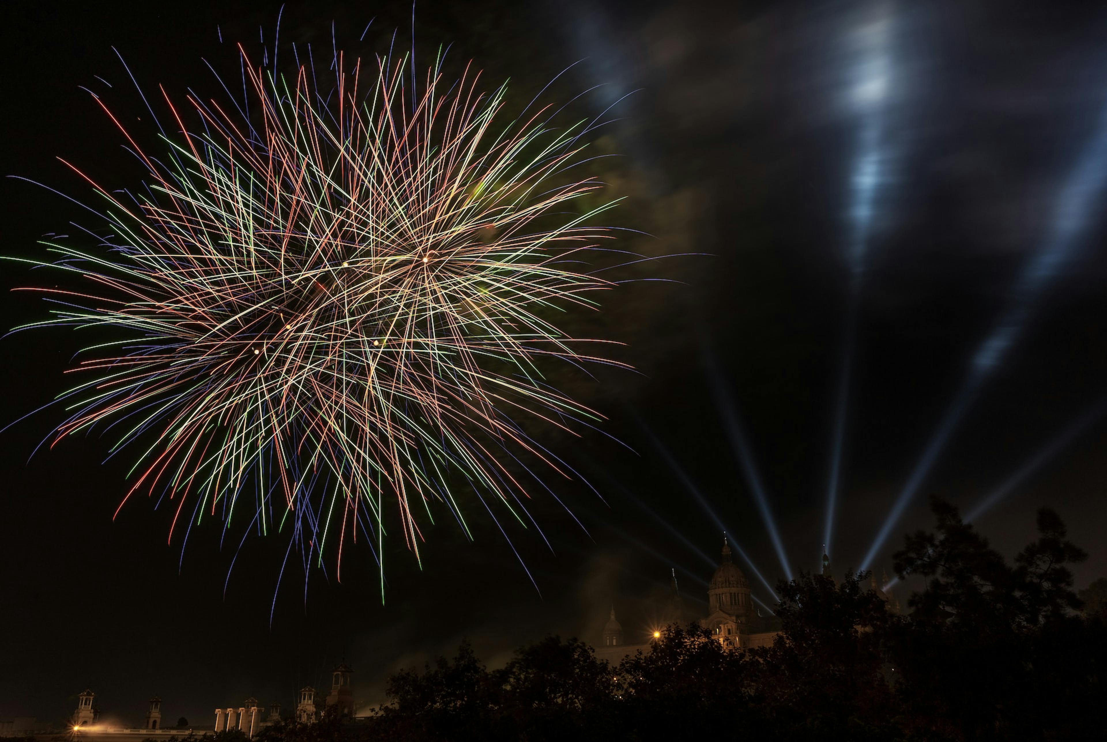 Fireworks illuminating the skyline during one of Barcelona festivals, creating a mesmerizing display of colors and lights.