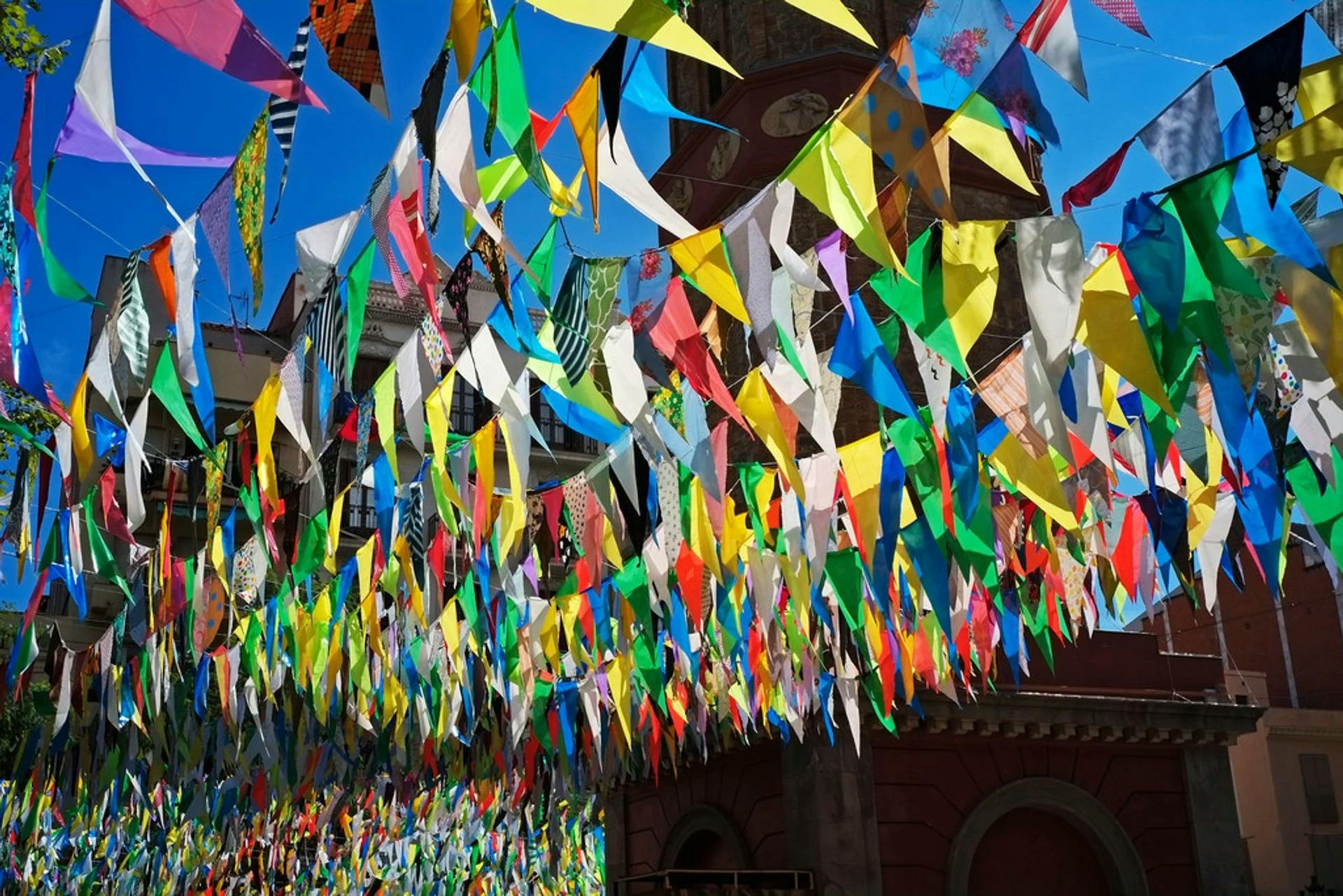 Colorful flags hanging in front of a building, adding vibrancy and festivity to the scene.