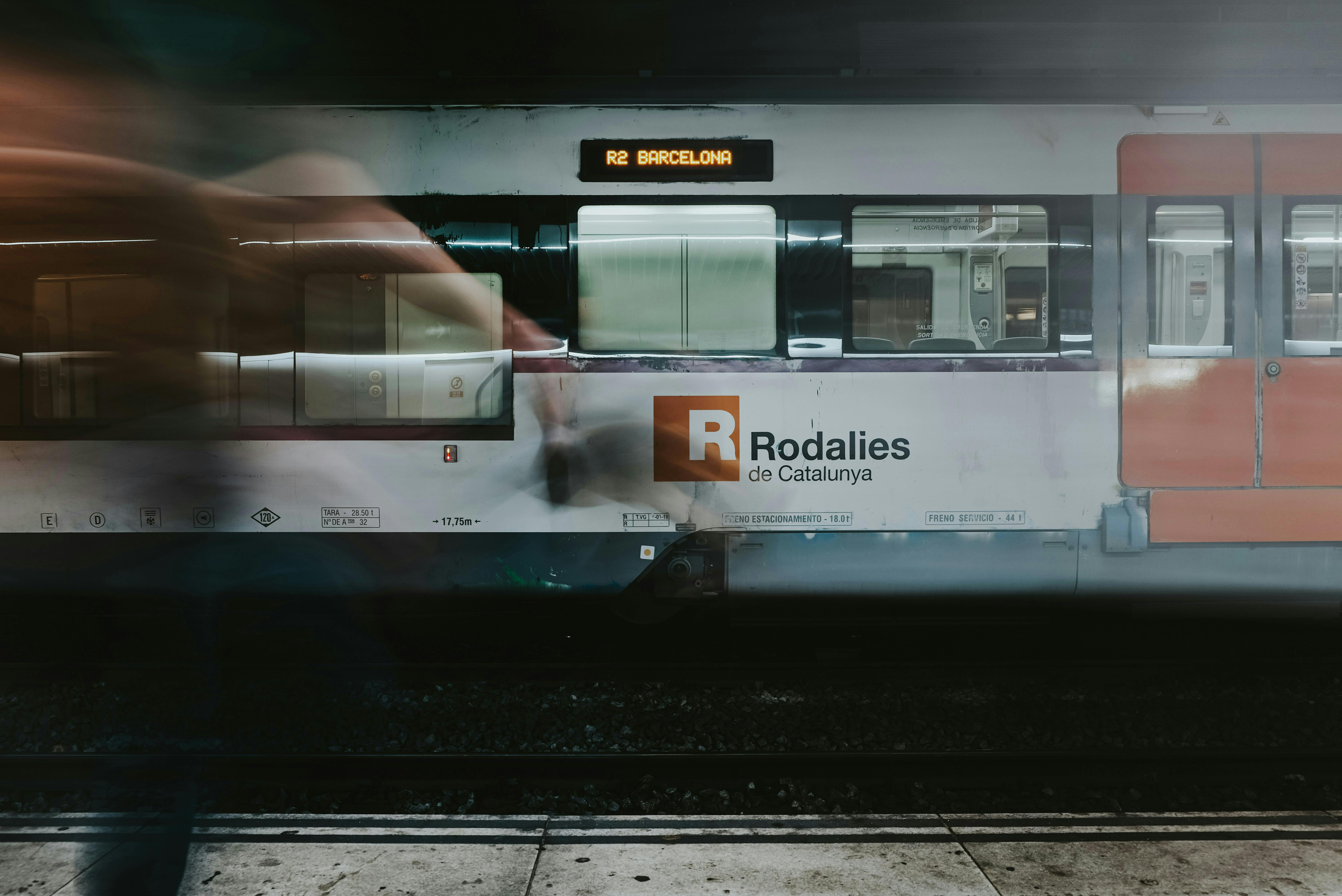 A train passing by a station during departure in Barcelona.