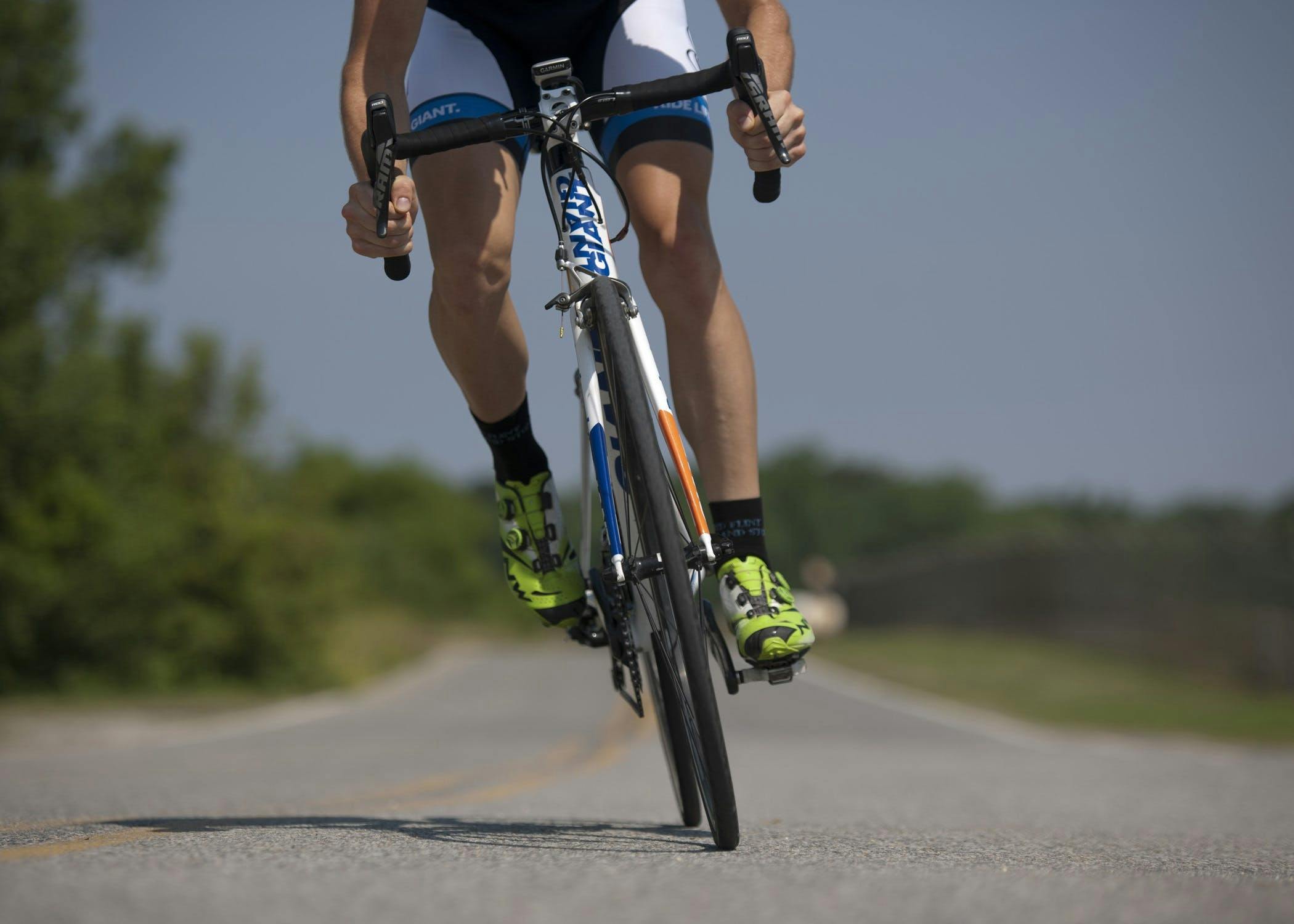 A person riding a bike on a road, covering a considerable distance on their bicycle.