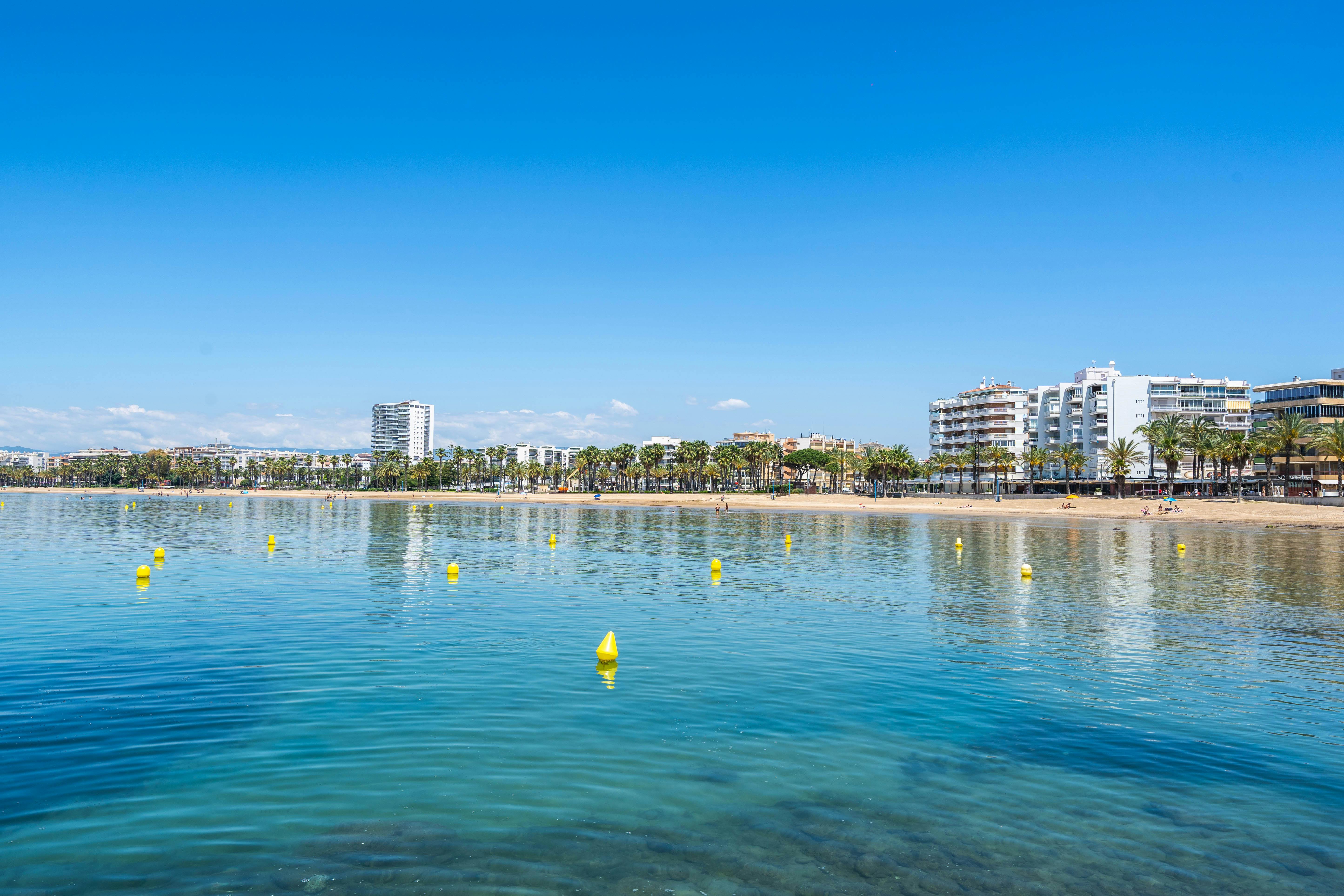 A lovely beach with sandy shore and bushes called Llevant Beach, located in Salou, Costa Dorada.