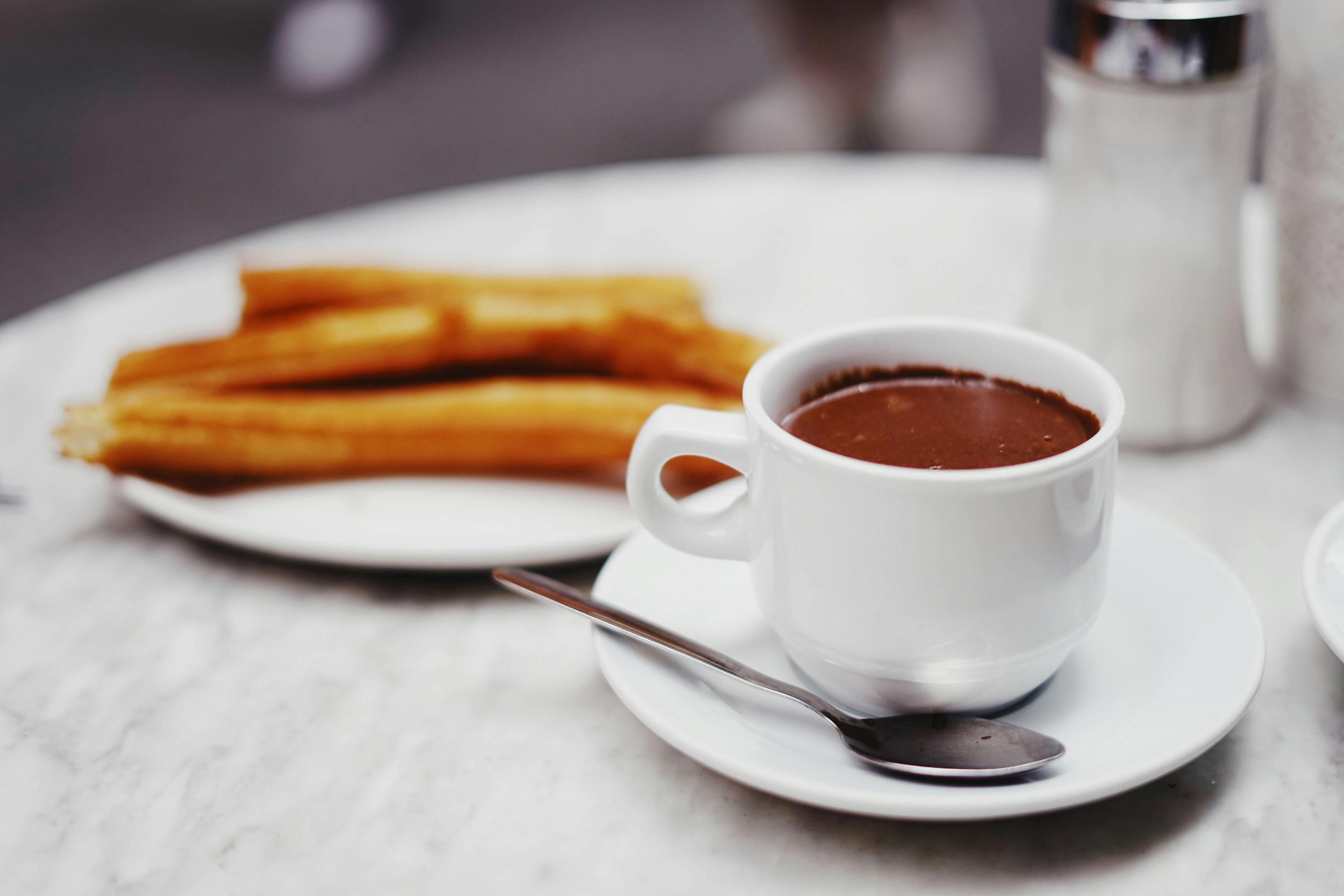 Churros and hot chocolate: a delectable treat enjoyed during a city break. A perfect combination of indulgence and warmth.