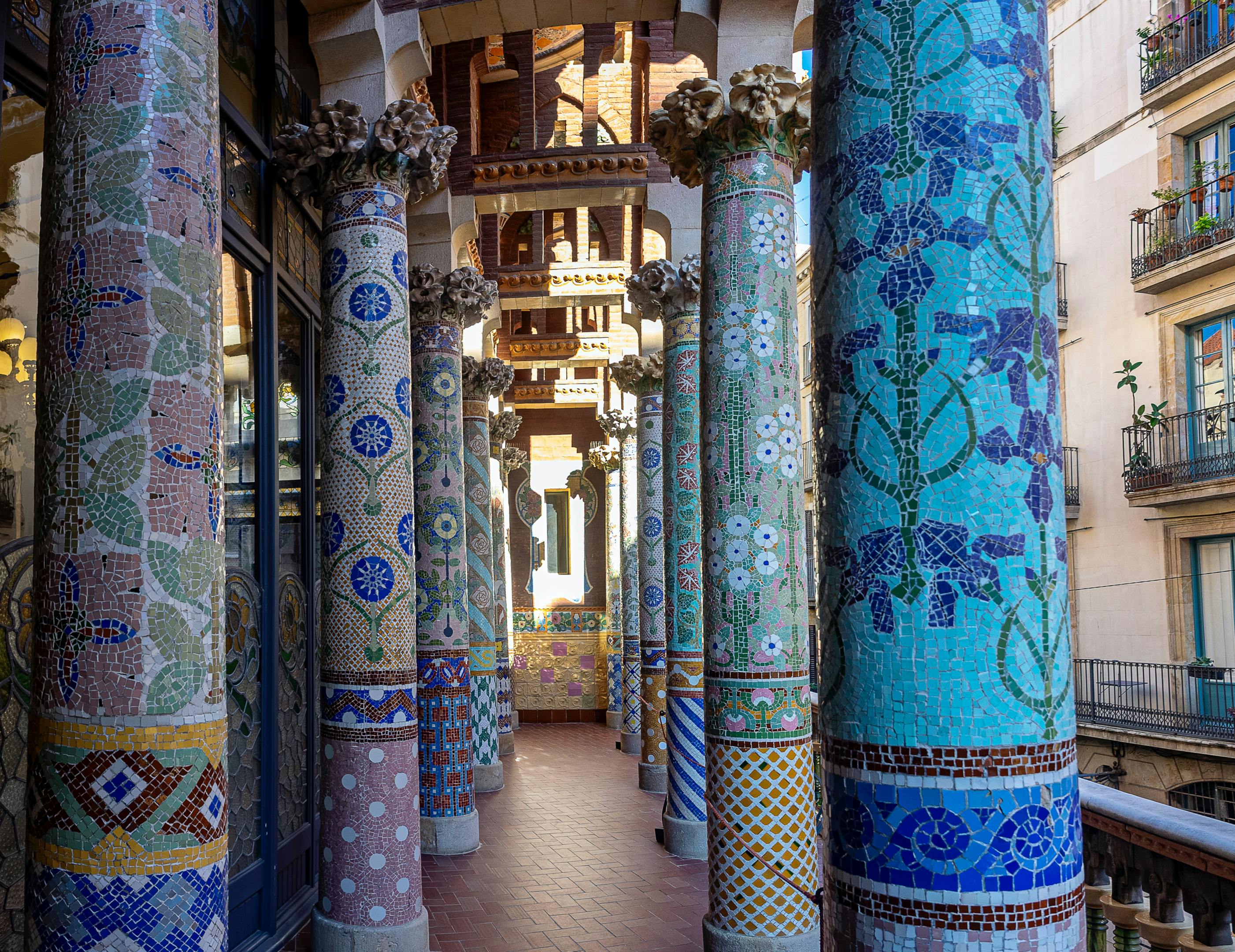 Inside the Catalan Music Palace, a long hallway adorned with colorful columns.