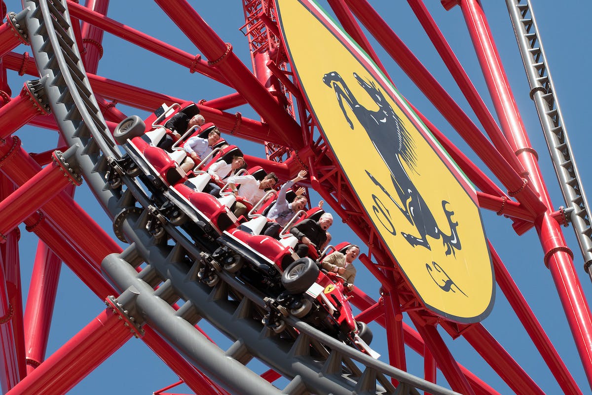 Thrilling ride at Ferrari Land Theme Park with excited passengers.